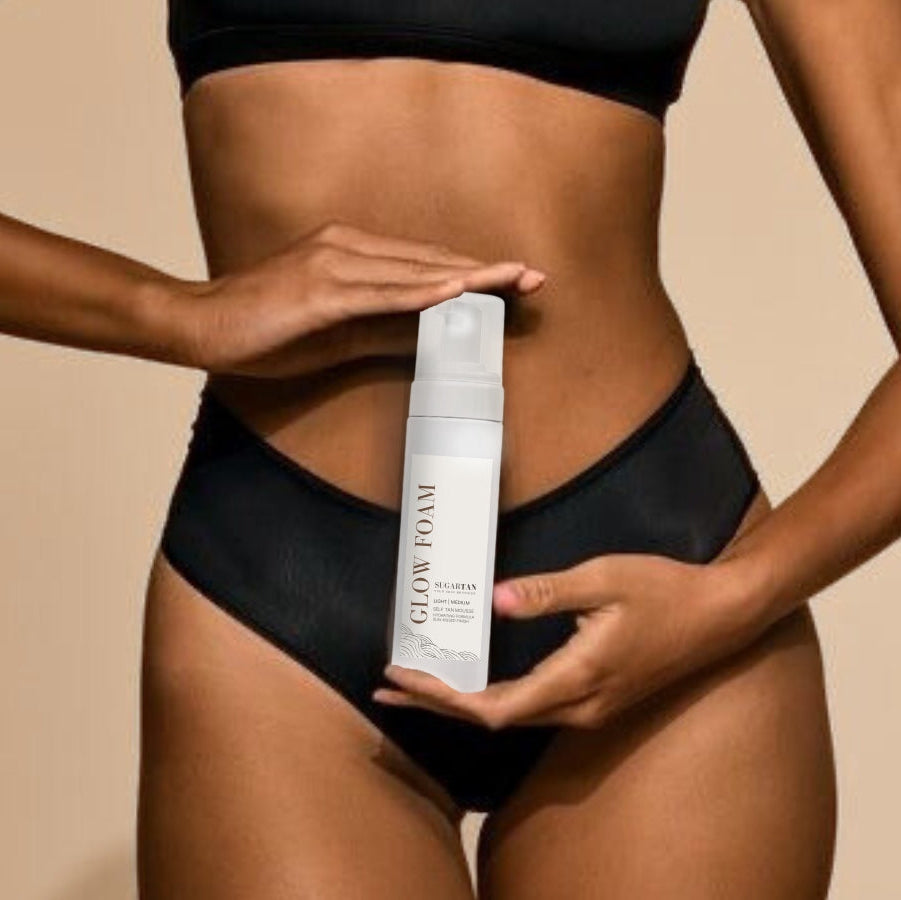 Person holding a bottle of 'Glow Time' product against a beige background